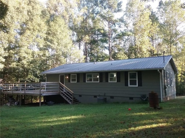 rear view of house featuring stairway, a wooden deck, metal roof, a yard, and crawl space