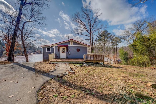 view of front of house featuring aphalt driveway and a wooden deck