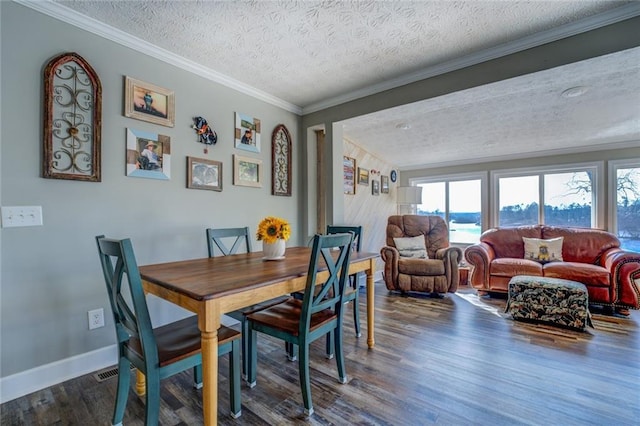 dining space with dark wood-type flooring, crown molding, a textured ceiling, and baseboards