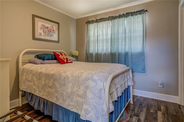 bedroom with baseboards, dark wood-style flooring, and ornamental molding