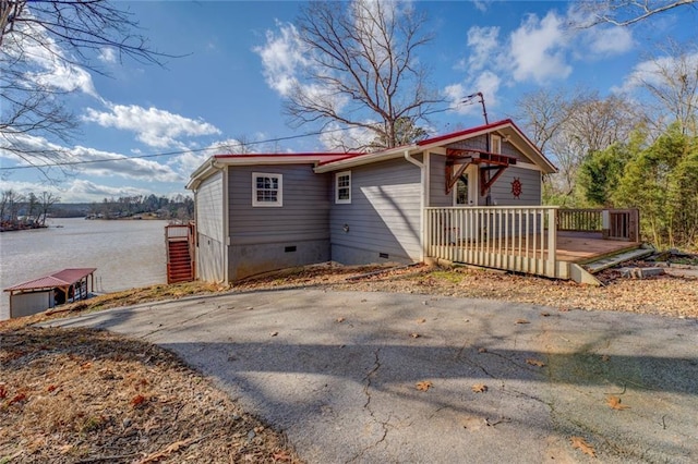 view of front of property featuring crawl space and a deck with water view