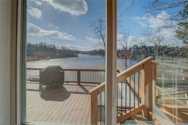 wooden deck with a water view and stairway