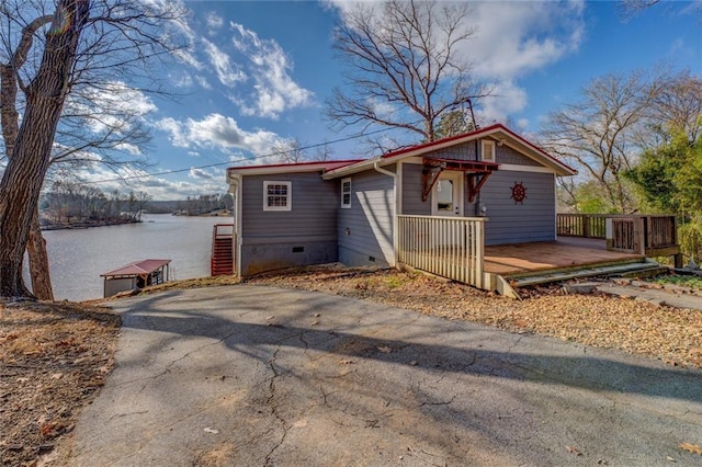 bungalow featuring crawl space and a deck with water view