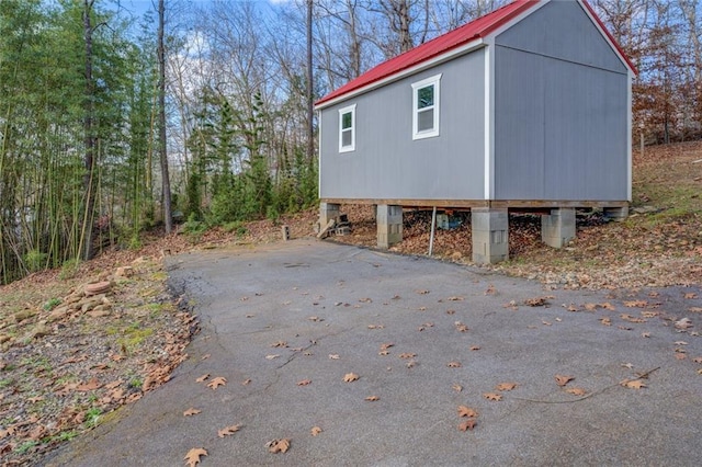 view of side of home with metal roof