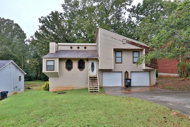 2715 Cordite Loop, Snellville, GA 30039 - view of front of property with asphalt driveway, a front lawn, an attached garage, a chimney, and view of scattered trees