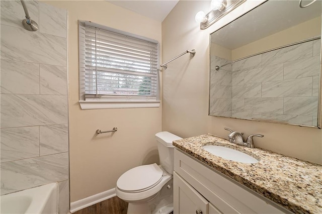 full bathroom with vanity, toilet, tiled shower / bath combo, and hardwood / wood-style floors