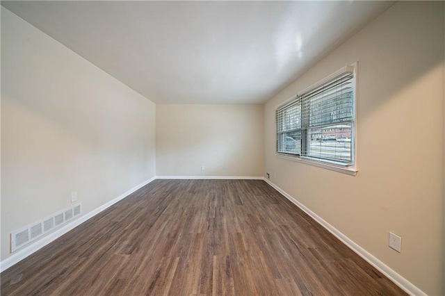 spare room featuring dark hardwood / wood-style flooring