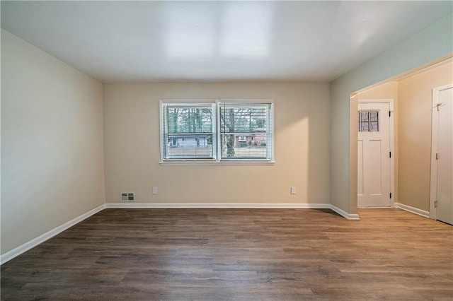 empty room with dark wood-type flooring