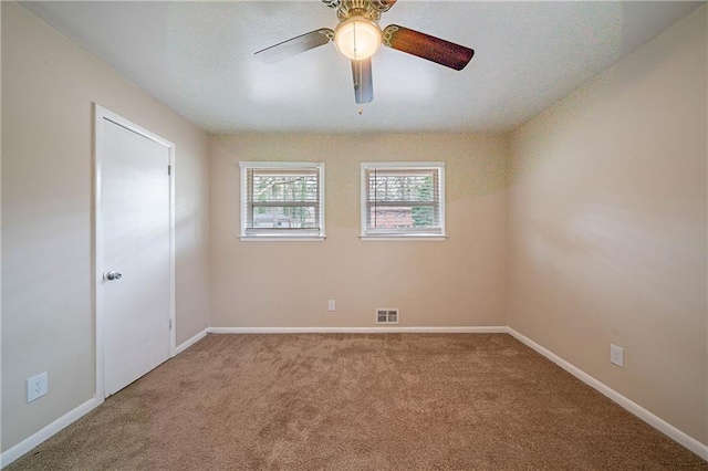 carpeted empty room with ceiling fan