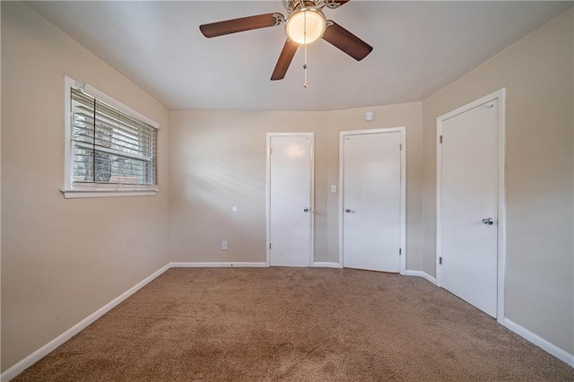 unfurnished bedroom featuring ceiling fan and carpet