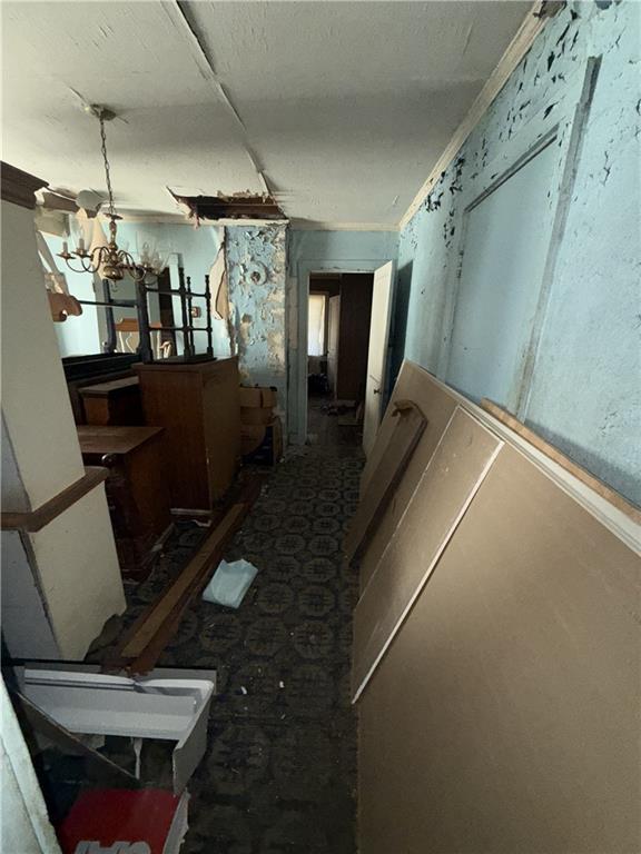 hallway with a chandelier