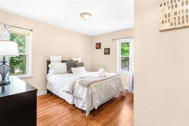 bedroom featuring wood finished floors and baseboards