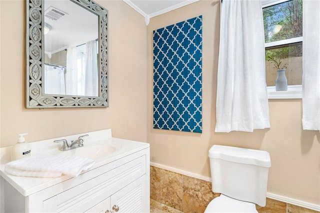 bathroom with baseboards, visible vents, toilet, crown molding, and vanity