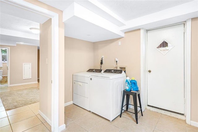 laundry room featuring washer and dryer, laundry area, baseboards, and light tile patterned floors