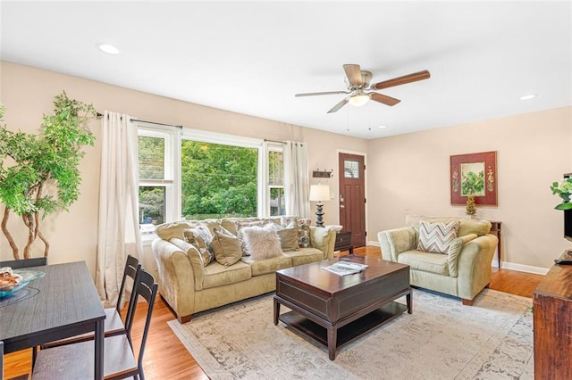 living area with ceiling fan, recessed lighting, light wood-type flooring, and baseboards