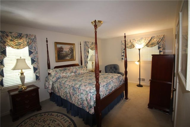 carpeted bedroom featuring visible vents and baseboards