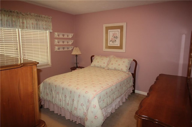 bedroom featuring carpet flooring and baseboards