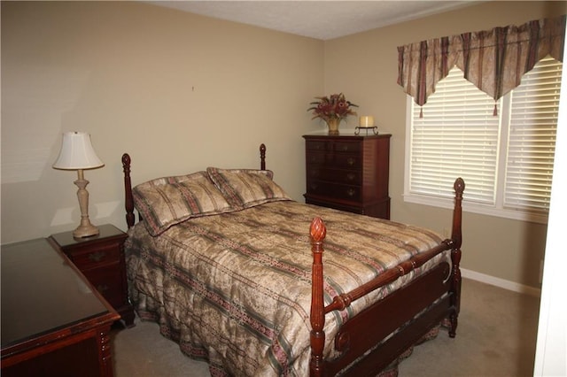 bedroom with carpet flooring and baseboards