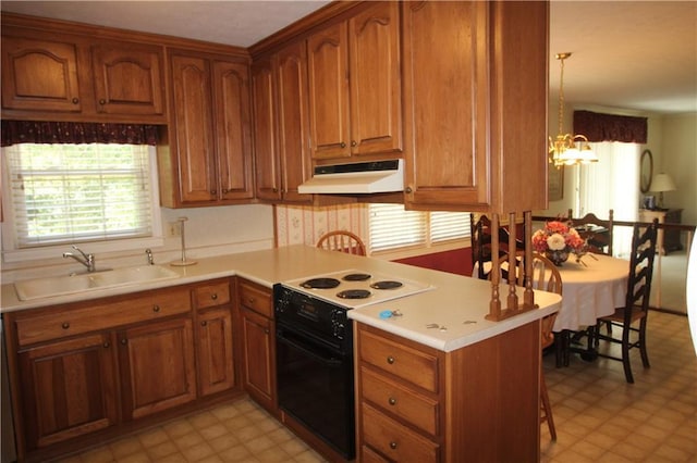kitchen with light floors, a sink, under cabinet range hood, and electric range
