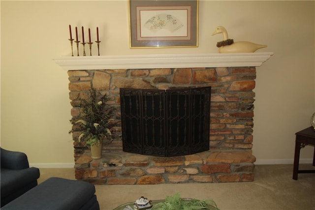 interior details featuring carpet floors, a stone fireplace, and baseboards