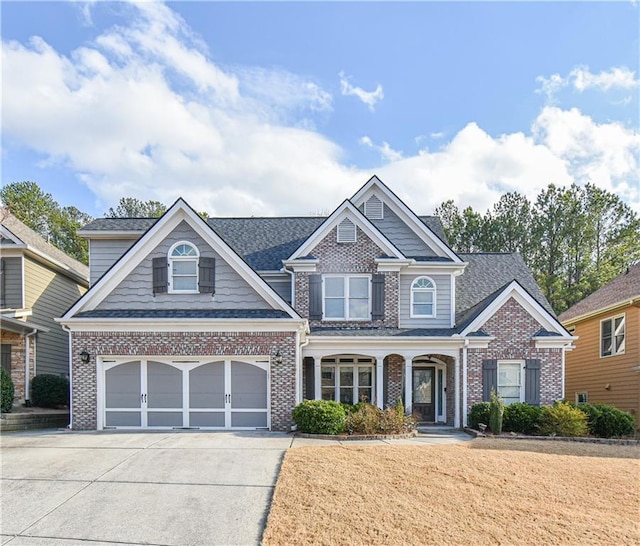 55 Little Barley Ln, Grayson, GA 30017 - craftsman-style house with brick siding, driveway, an attached garage, a front lawn, and covered porch