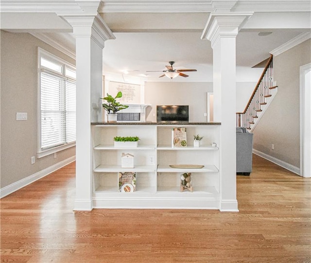 55 Little Barley Ln, Grayson, GA 30017 - interior space with decorative columns, a ceiling fan, baseboards, light wood-type flooring, and ornamental molding