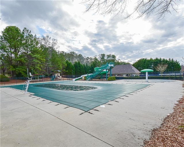 55 Little Barley Ln, Grayson, GA 30017 - community pool with a water slide, fence, a patio area, and view of wooded area