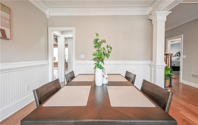 55 Little Barley Ln, Grayson, GA 30017 - dining room with ornate columns, ornamental molding, wood finished floors, and a wainscoted wall