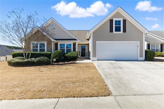 view of front facade featuring concrete driveway and a front lawn