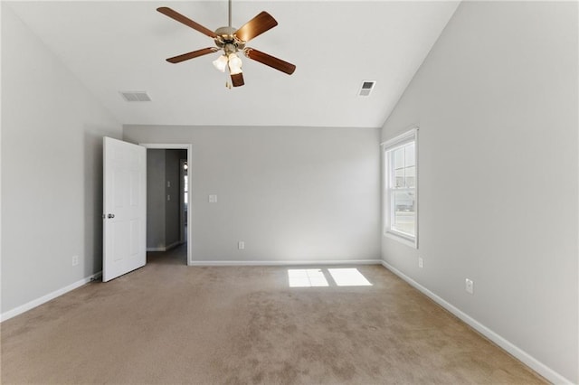 spare room with carpet floors, baseboards, and visible vents