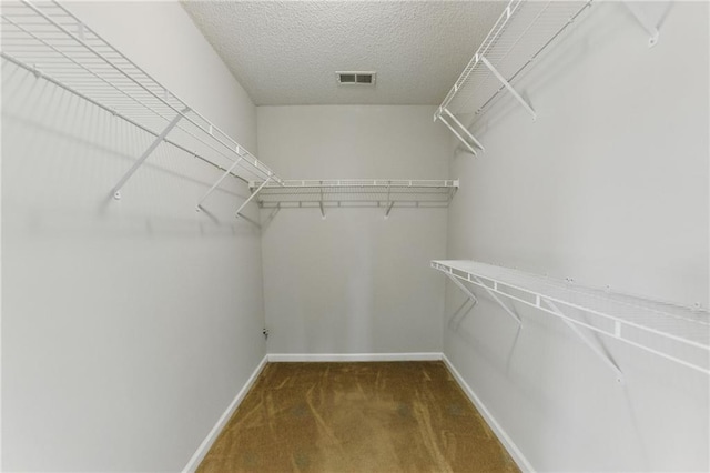 walk in closet featuring carpet flooring and visible vents