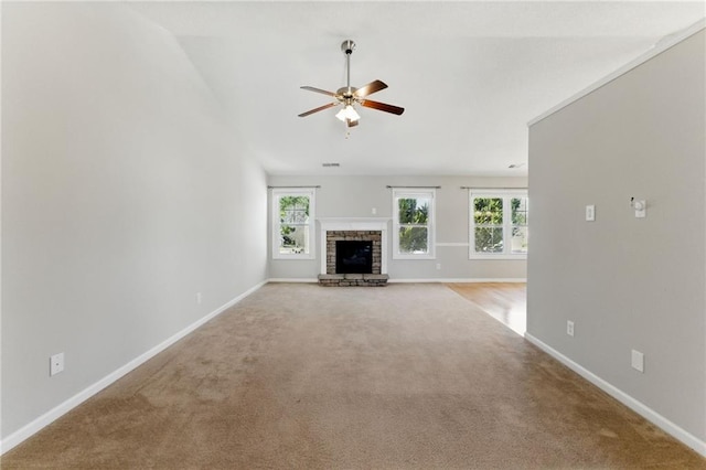 unfurnished living room with a brick fireplace, carpet, and baseboards