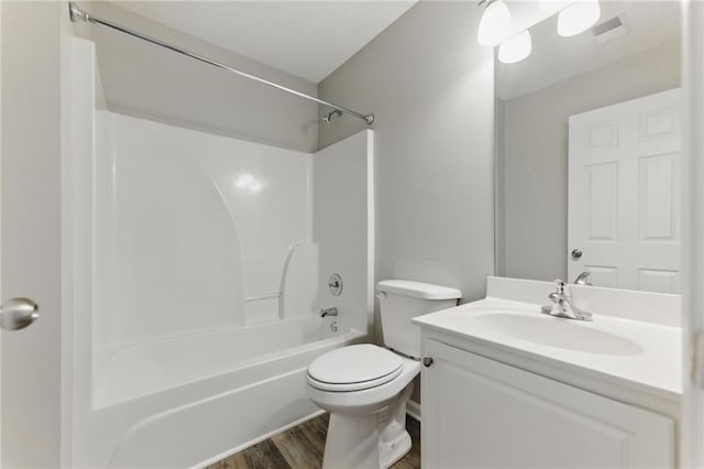 bathroom featuring toilet, shower / bath combination, wood finished floors, visible vents, and vanity