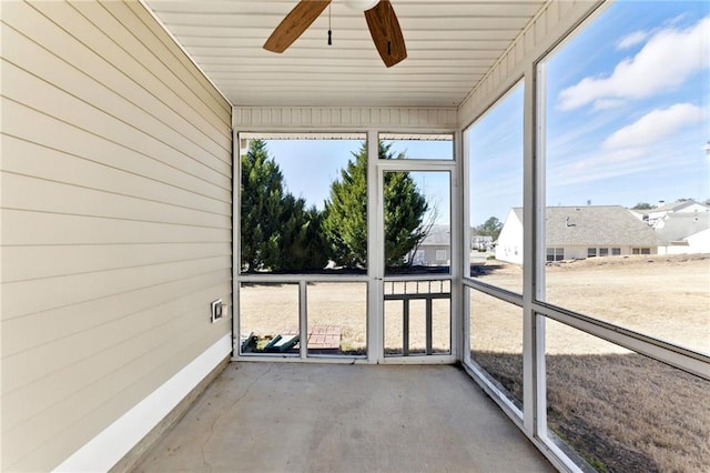 unfurnished sunroom featuring a ceiling fan