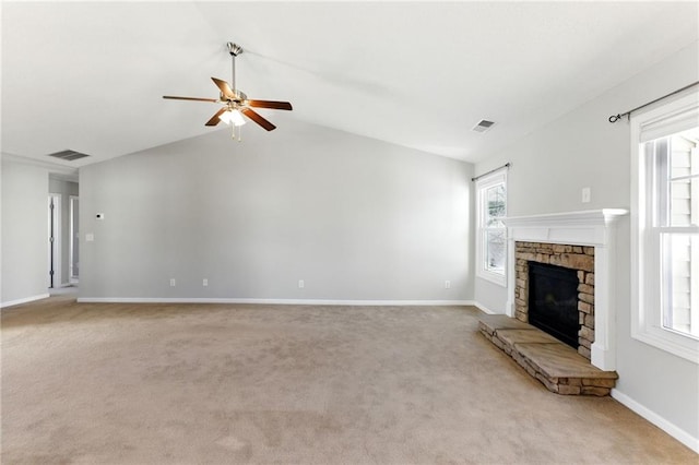 unfurnished living room with light colored carpet, visible vents, a fireplace, and baseboards