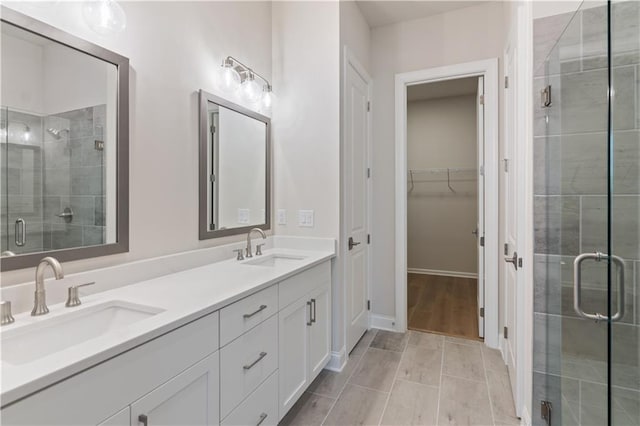 bathroom with an enclosed shower and vanity