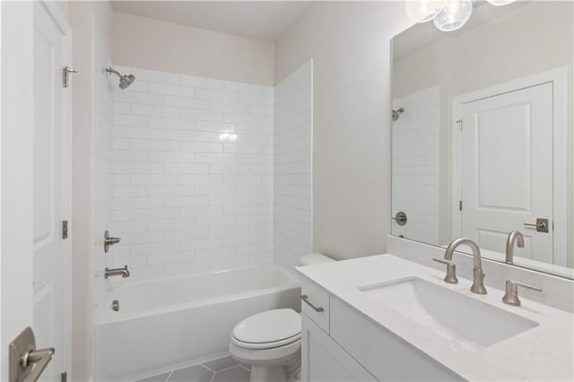 full bathroom with tile patterned flooring, tiled shower / bath combo, vanity, and toilet