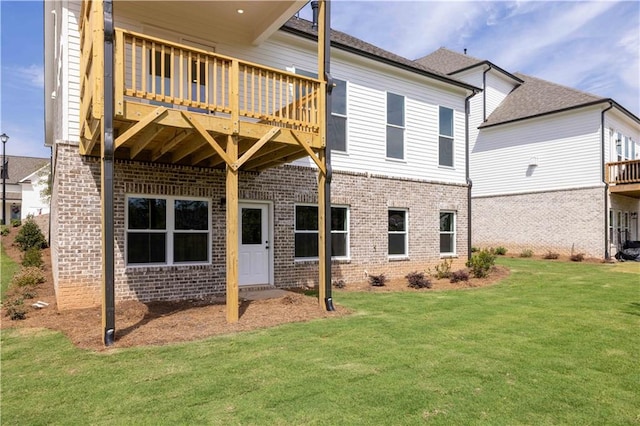 back of house featuring a yard and a balcony