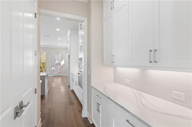 hall featuring dark hardwood / wood-style floors and crown molding