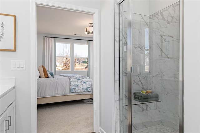 full bath featuring a marble finish shower, vanity, and ensuite bath