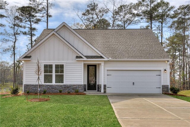 craftsman-style home with a shingled roof, concrete driveway, an attached garage, board and batten siding, and a front lawn