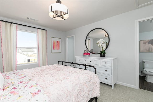 bedroom with baseboards, visible vents, and light colored carpet