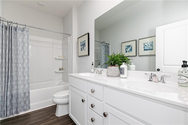 bathroom featuring shower / tub combo with curtain, double vanity, a sink, and wood finished floors