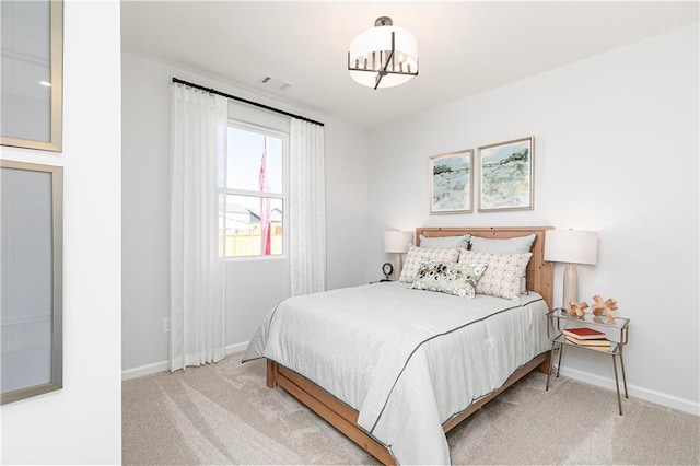 bedroom featuring visible vents, baseboards, and light colored carpet