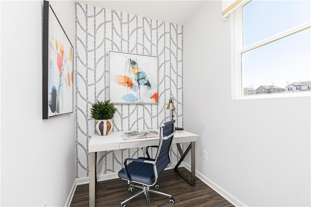 office area featuring an accent wall, baseboards, and wood finished floors