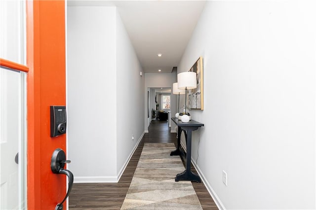 hall featuring dark wood finished floors and baseboards