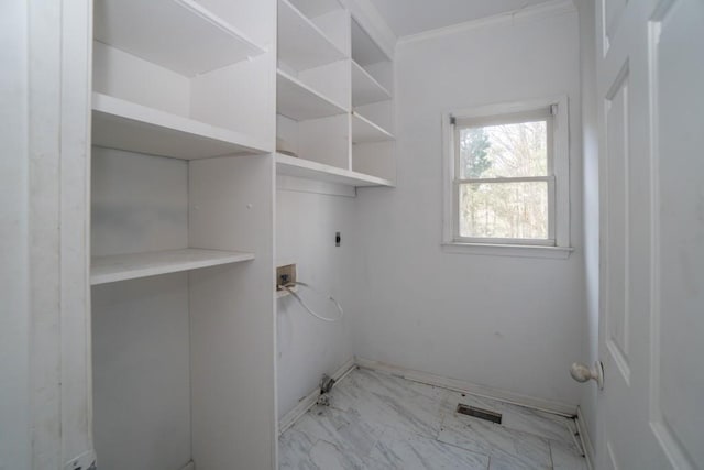 clothes washing area with washer hookup, ornamental molding, laundry area, marble finish floor, and electric dryer hookup