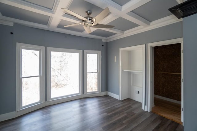 unfurnished bedroom with beam ceiling, coffered ceiling, dark wood-style floors, crown molding, and baseboards