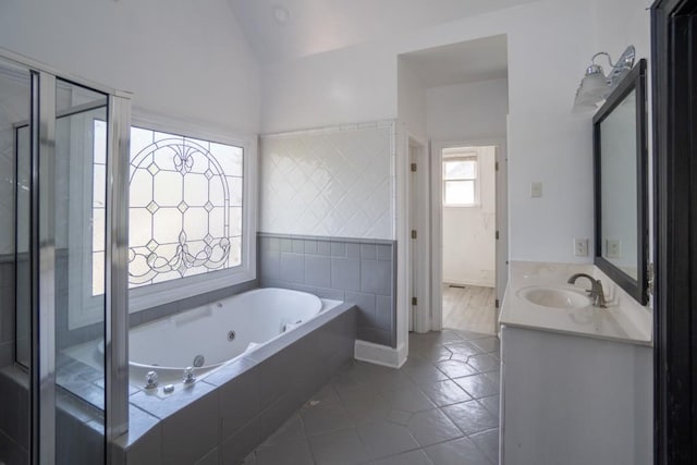 full bath with lofted ceiling, a whirlpool tub, a stall shower, tile patterned floors, and vanity