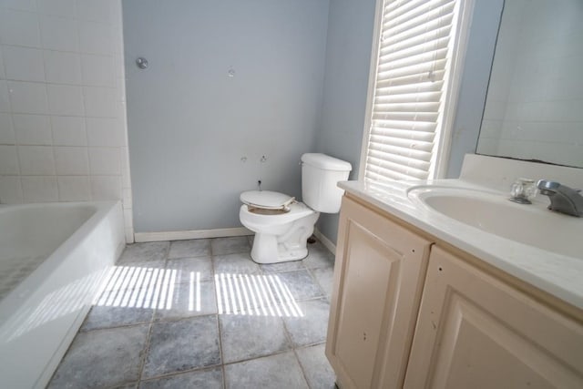 full bath featuring toilet, tile patterned flooring, baseboards, a bathtub, and vanity